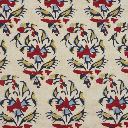 A Vijani Teak Fabric by John Robshaw, hand block printed with traditional craftsmanship, featuring beige color and vibrant designs in red, blue, and yellow.
