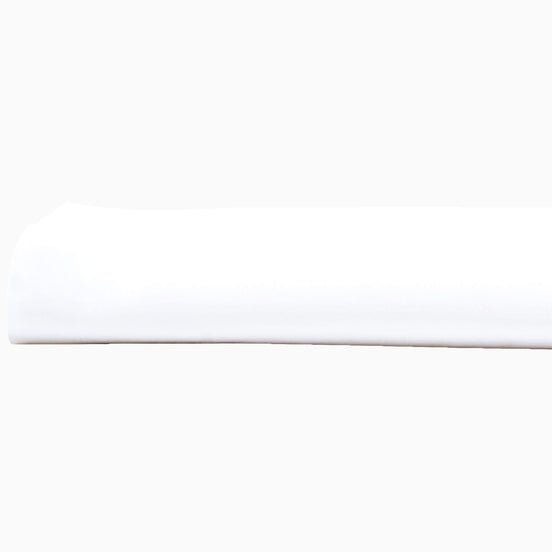 A John Robshaw Organic White Fitted Sheet, made of organic cotton, lying on top of a white surface in India.